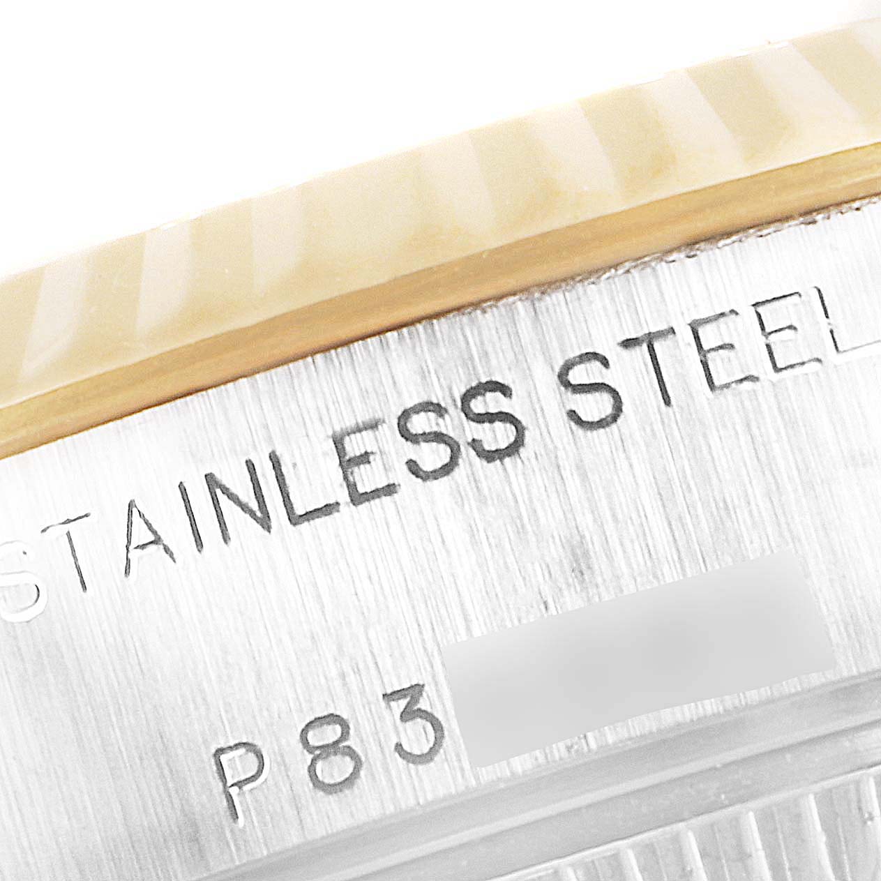 This close-up image shows the side engraving of the Rolex Datejust 69173 Women's Steel and Gold (two tone) Champagne Dial 69173 Women's Steel and Gold (two tone) Champagne Dial watch with "STAINLESS STEEL" and part of the model number.