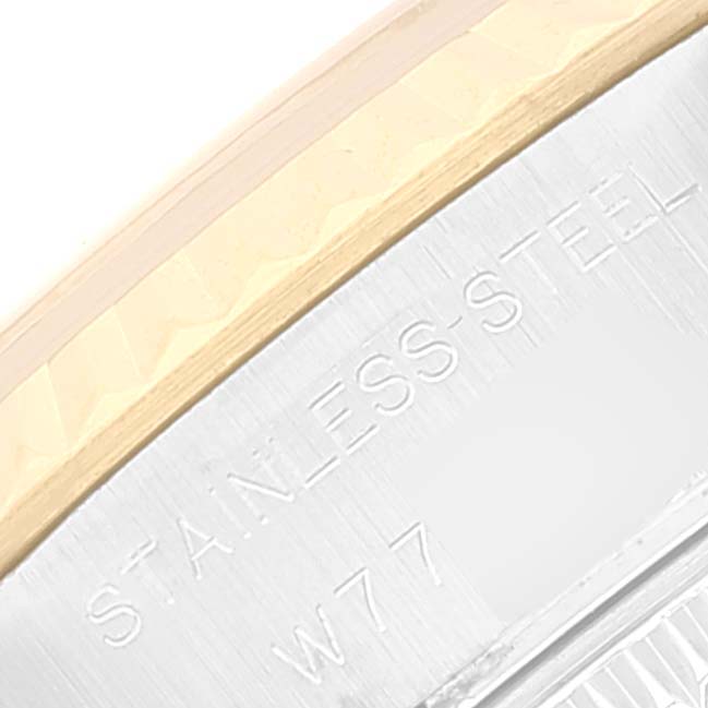 This image shows a close-up angle of the Rolex Datejust 69173 Women's Steel and Gold (two tone) Red Dial 69173 Women's Steel and Gold (two tone) Red Dial watch's bezel and case with "STAINLESS STEEL" engraving.