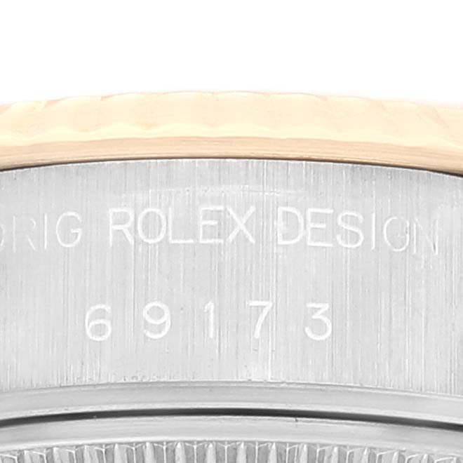 The image shows a close-up of the serial number engraving on the side of a Rolex Datejust 69173 Women's Steel and Gold (two tone) Champagne Dial 69173 Women's Steel and Gold (two tone) Champagne Dial watch case.