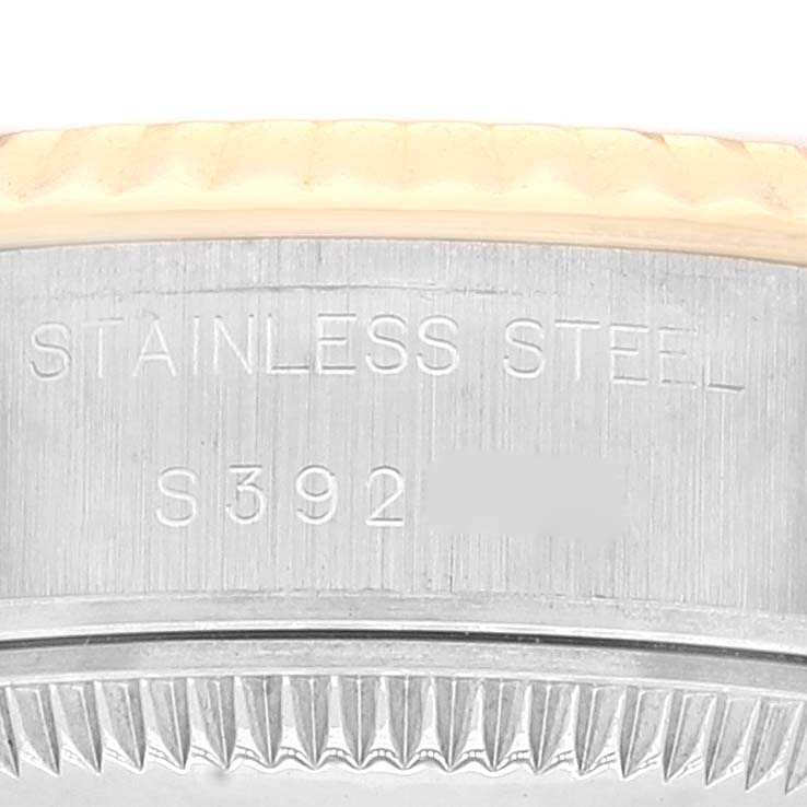 This close-up image of the Rolex Datejust 69173 Women's Steel and Gold (two tone) Champagne Dial 69173 Women's Steel and Gold (two tone) Champagne Dial watch shows the side of the case with engravings and part of the bezel.