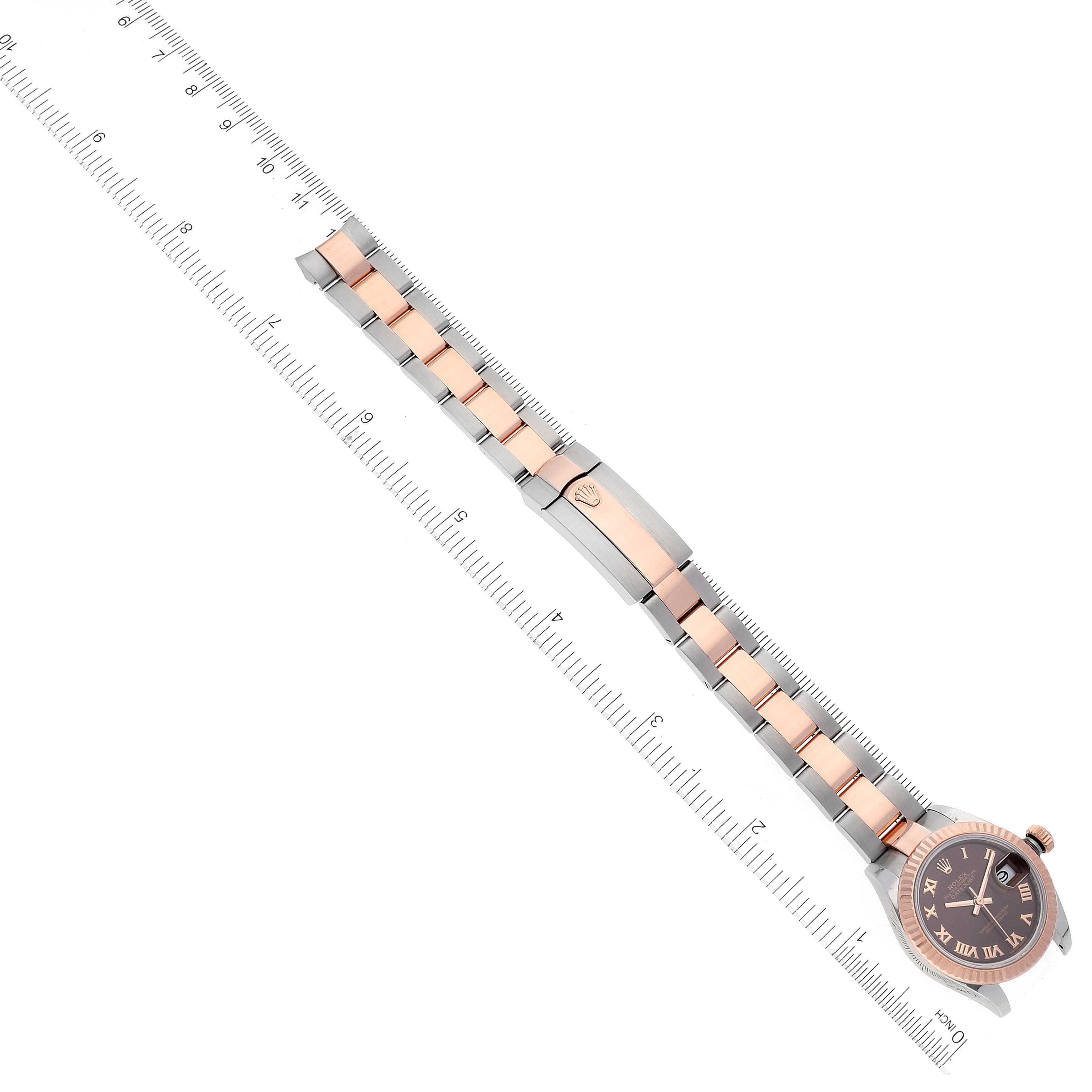 The image shows a top-down view of a Rolex Datejust 279171 Women's Steel and Gold (two tone) Brown Dial 279171 Women's Steel and Gold (two tone) Brown Dial watch, highlighting the dial, bezel, and bracelet alongside a ruler for scale.