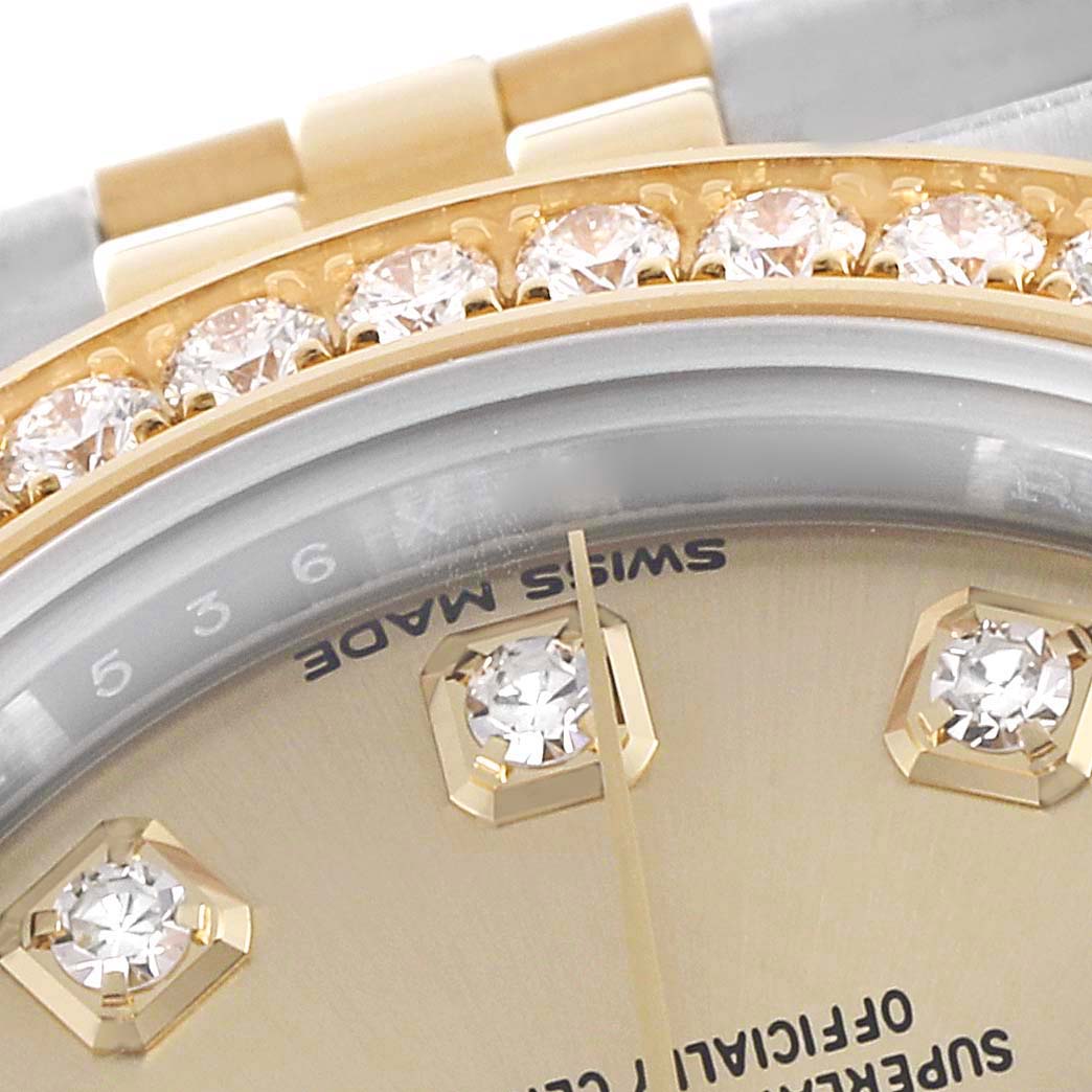 This close-up image of the Rolex Datejust 279383 Women's Steel and Gold (two tone) Champagne Dial 279383 Women's Steel and Gold (two tone) Champagne Dial watch showcases the diamond-set bezel and portions of the dial with diamond hour markers.