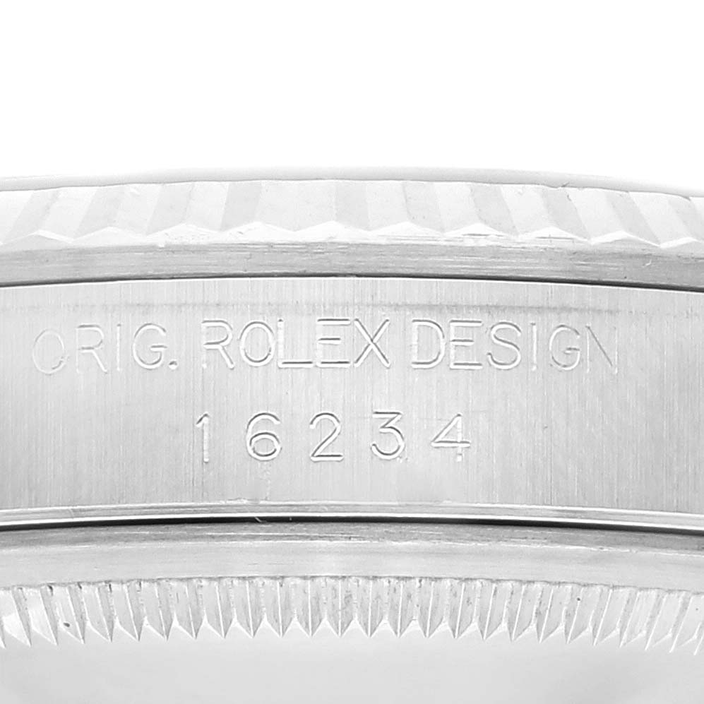 This image shows the side of the bezel and case of a Rolex Datejust 16234 Men's Stainless Steel Silver Dial 16234 Men's Stainless Steel Silver Dial with engraved text.