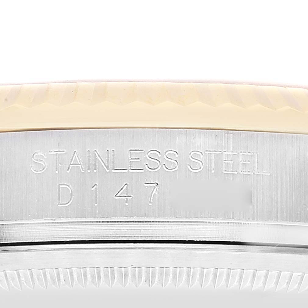 This image shows an angled close-up of the stainless steel case side of a Rolex Datejust 116233 Men's Steel and Gold (two tone) Champagne Dial 116233 Men's Steel and Gold (two tone) Champagne Dial, featuring the engraved model details.