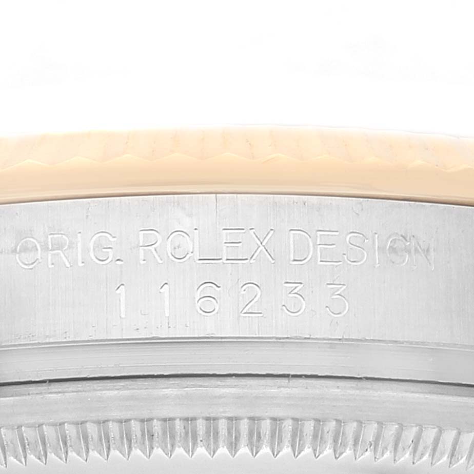 This close-up shows the engraved side of the case of a Rolex Datejust 116233 Men's Steel and Gold (two tone) Champagne Dial 116233 Men's Steel and Gold (two tone) Champagne Dial watch, highlighting the model number and "Orig. Rolex Design".