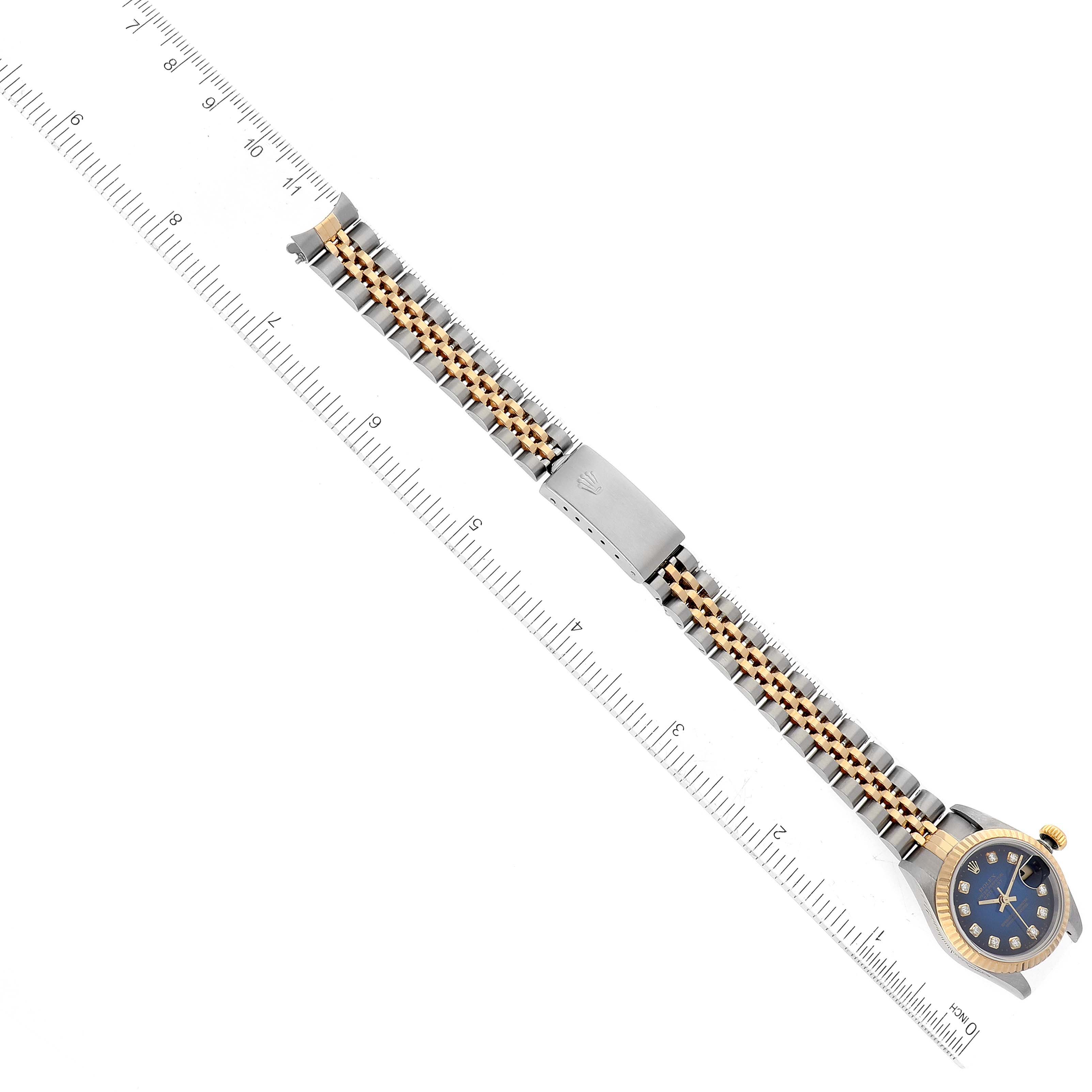 The image shows a top-down view of a Rolex Datejust 69173 Women's Steel and Gold (two tone) Blue Dial 69173 Women's Steel and Gold (two tone) Blue Dial watch, including the face, strap, and clasp against a measurement ruler.