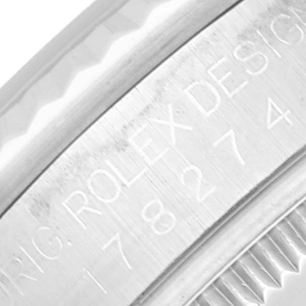 This close-up image shows part of the bezel and engraving on the case of a Rolex Mid-Size 178274 Women's Stainless Steel Silver Dial 178274 Women's Stainless Steel Silver Dial model watch.