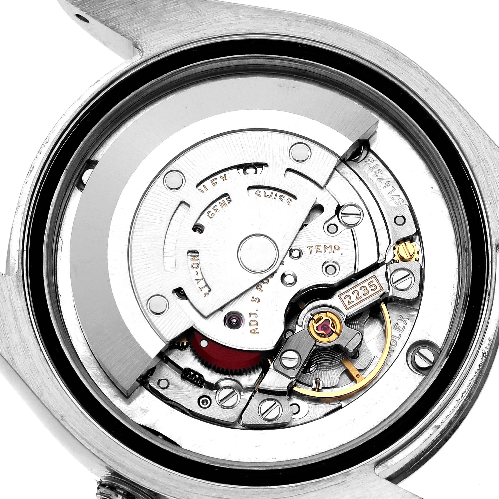 The image shows the inner mechanical movement of a Rolex Mid-Size 178274 Women's Stainless Steel Silver Dial watch viewed from the back with detailed gears and components visible.