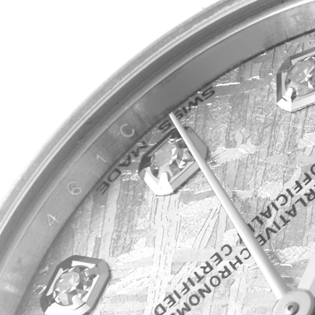 This close-up of a Rolex Mid-Size 178274 Women's Stainless Steel Silver Dial watch shows part of the dial with diamond markers and a portion of the minute hand.