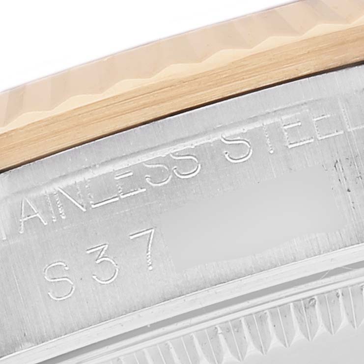 This image shows a close-up of the side of a mid-size Rolex watch case with part of the model and "STAINLESS STEEL" engraved.