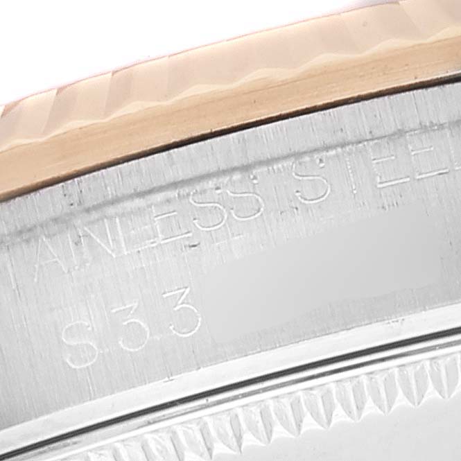 This image shows a close-up of the bezel and case side of the Rolex Mid-Size 68273 Women's Steel and Gold (two tone) Champagne Dial 68273 Women's Steel and Gold (two tone) Champagne Dial watch, highlighting the stainless steel inscription.