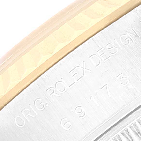 This image shows a close-up of the side of the bezel and case with engravings of a Rolex Datejust 69173 Women's Steel and Gold (two tone) Silver Dial 69173 Women's Steel and Gold (two tone) Silver Dial watch.