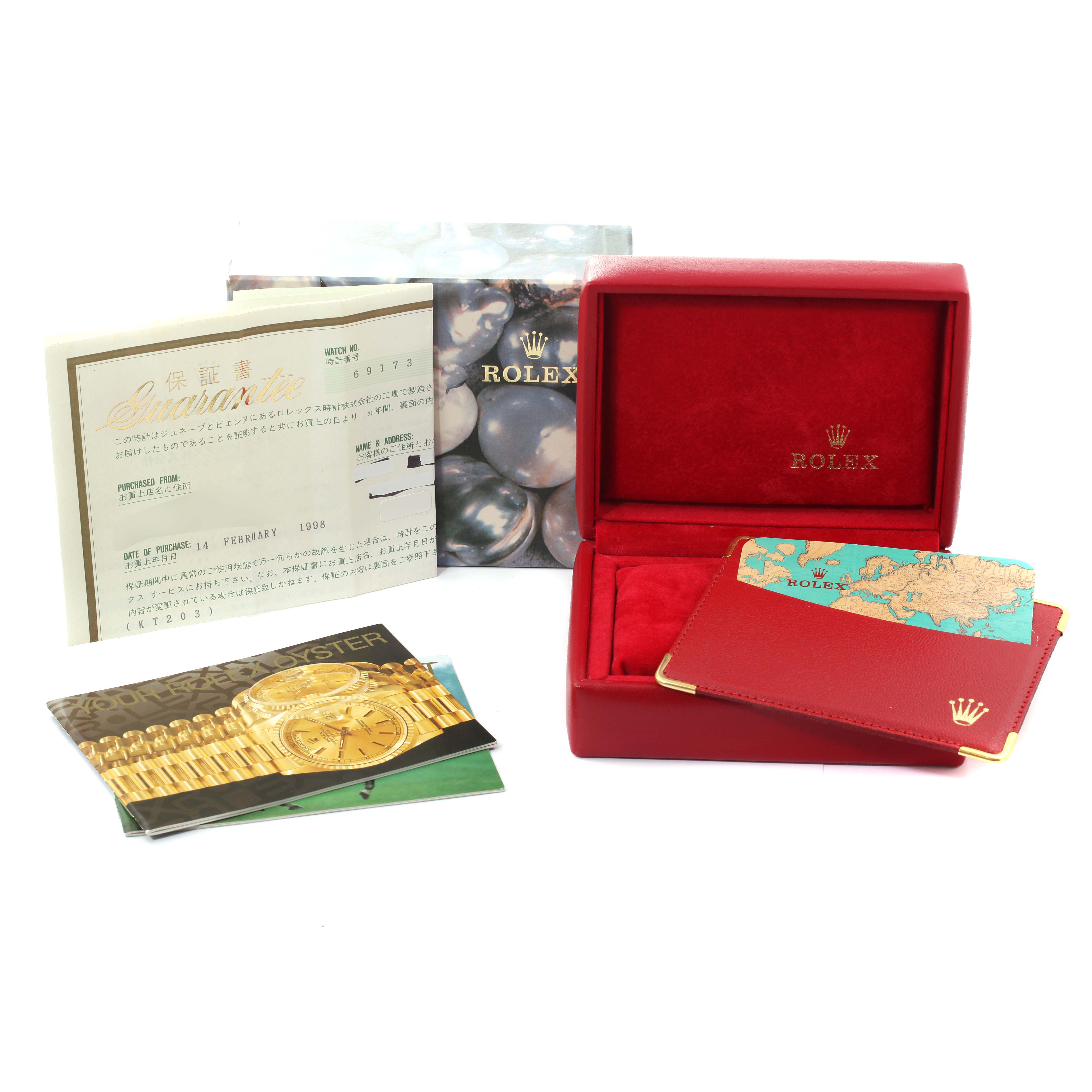 This image shows the accessories of a Rolex Datejust 69173 Women's Steel and Gold (two tone) Silver Dial 69173 Women's Steel and Gold (two tone) Silver Dial watch, including the box, warranty cards, and documentation from an angled view.