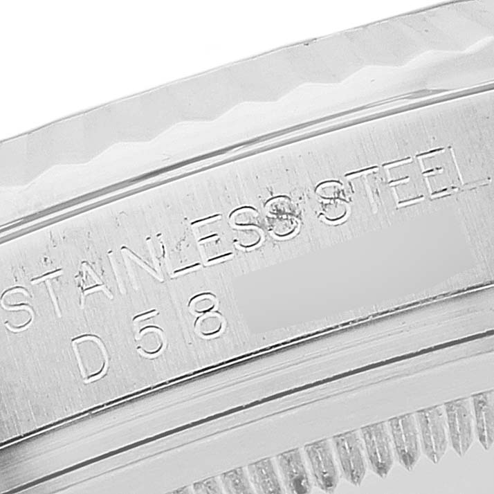 This image shows a close-up of the side of a stainless steel bezel of a Rolex Datejust 116234 Men's Stainless Steel Black Dial 116234 Men's Stainless Steel Black Dial watch, highlighting the engraved text.