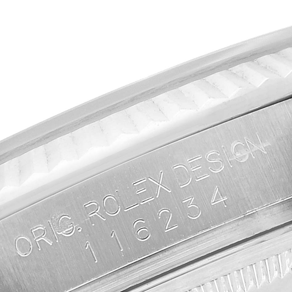 The image shows a close-up of the side of a Rolex Datejust 116234 Men's Stainless Steel Silver Dial 116234 Men's Stainless Steel Silver Dial watch, specifically focusing on the engraved serial number and "ORG. ROLEX DESIGN."
