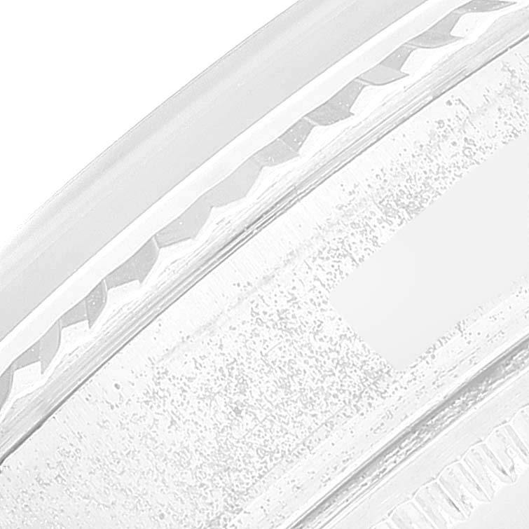 The image shows a close-up of the side edge of the bezel of a Rolex Vintage Collection 1601 Men
s Stainless Steel Silver Dial 1601 Men
s Stainless Steel Silver Dial watch.
