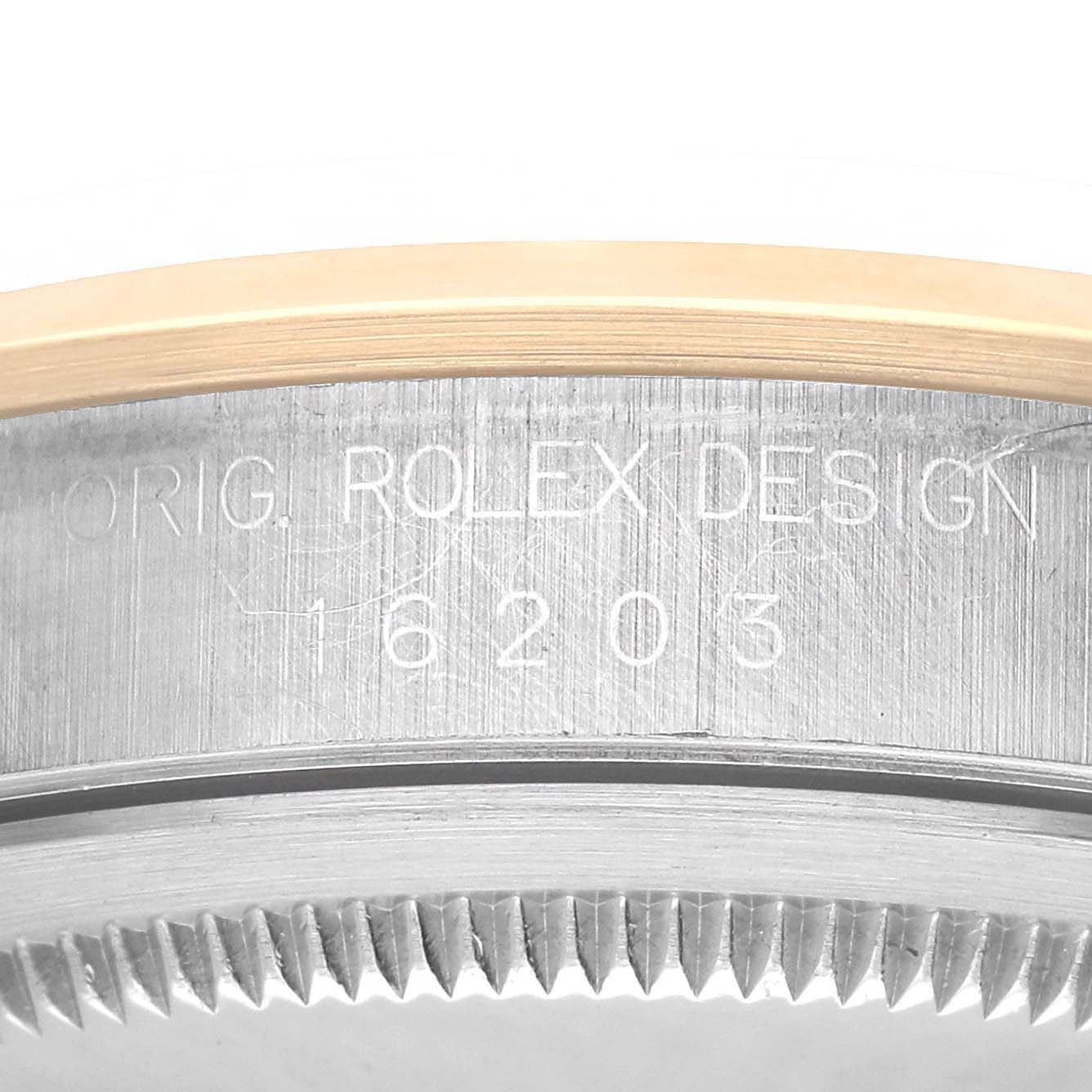 The image shows a close-up side view of the bezel and case number engraving on a Rolex Datejust 16203 Men's Steel and Gold (two tone) Black Dial.