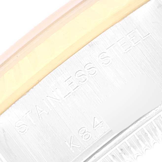 This image shows a close-up of the stainless steel and gold parts of a Rolex Datejust 79173 Women's Steel and Gold (two tone) Silver Dial 79173 Women's Steel and Gold (two tone) Silver Dial watch, highlighting the engraving.