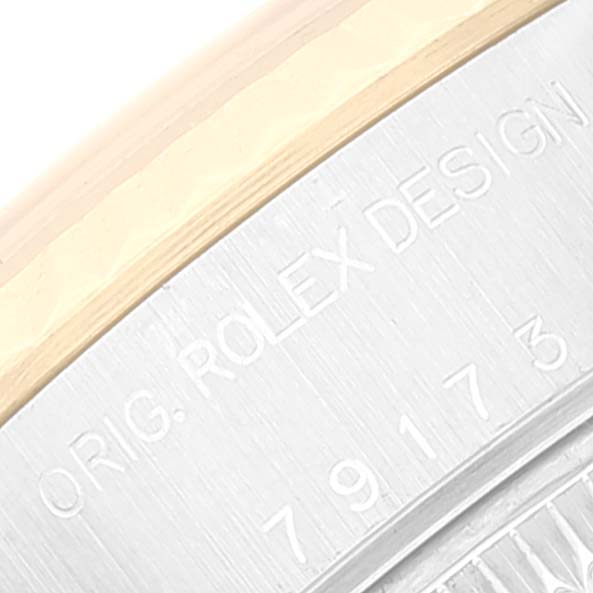 The image shows a close-up of the engraved caseback edge of a Rolex Datejust 79173 Women's Steel and Gold (two tone) Silver Dial 79173 Women's Steel and Gold (two tone) Silver Dial watch.