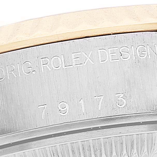 This image shows a partial view of the case and serial number of a Rolex Datejust 79173 Women's Steel and Gold (two tone) Silver Dial 79173 Women's Steel and Gold (two tone) Silver Dial watch, model 79173.