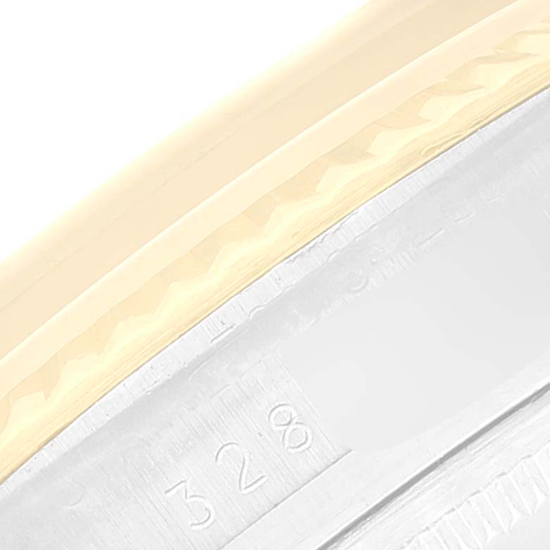 This image shows a close-up view of the bezel and part of the casing of the Rolex Vintage Collection 1601 Men's Steel and Gold (two tone) Champagne Dial 1601 Men's Steel and Gold (two tone) Champagne Dial model watch, highlighting its detailing and engravings.