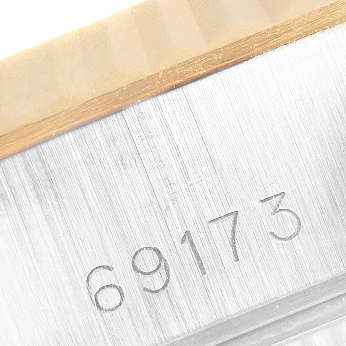 This image shows a close-up of the case side and serial number of a Rolex Datejust 69173 Women's Steel and Gold (two tone) Champagne Dial 69173 Women's Steel and Gold (two tone) Champagne Dial model with visible engraving "69173."