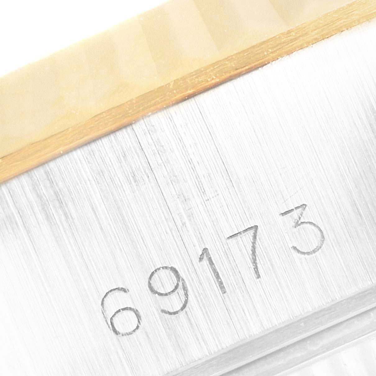 The image shows a close-up of the model number "69173" engraved on the side of a Rolex Datejust 69173 Women
s Steel and Gold (two tone) Champagne Dial 69173 Women
s Steel and Gold (two tone) Champagne Dial watch.