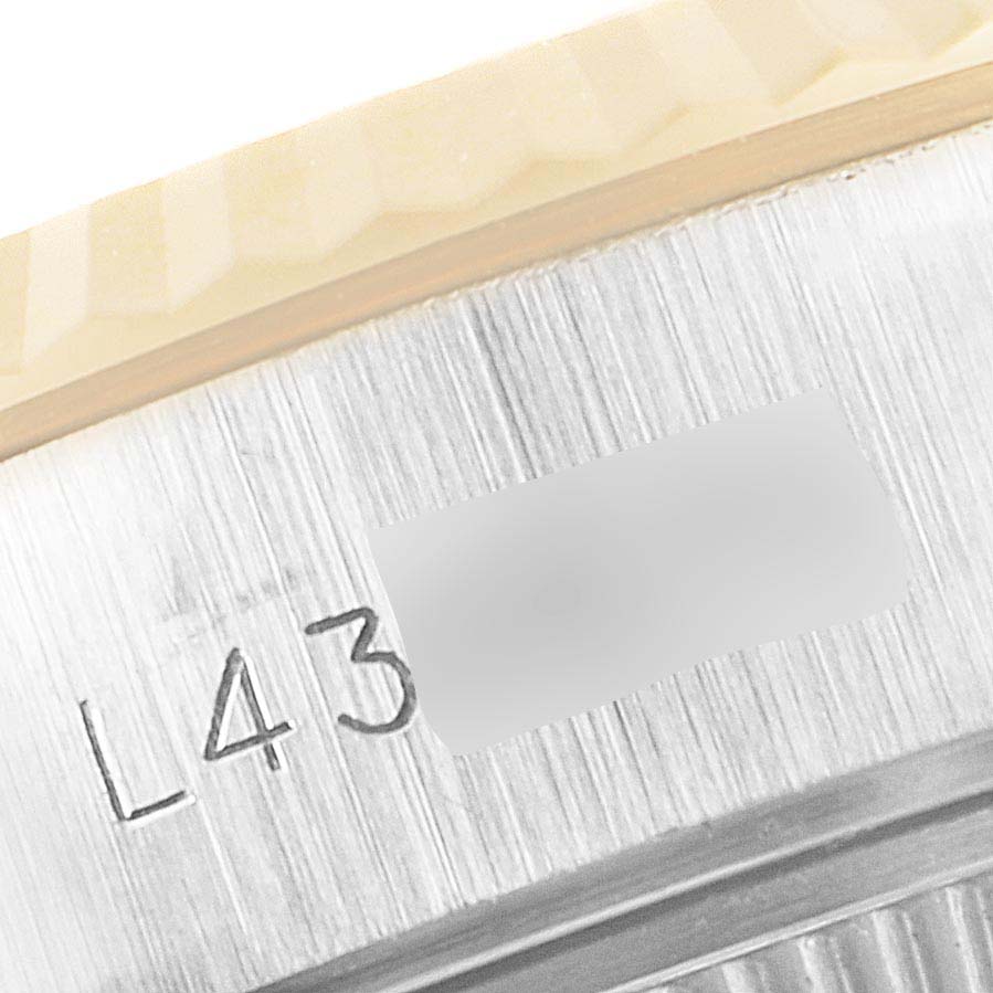 The image shows a close-up of the side of the case with engravings of a Rolex Datejust 69173 Women's Steel and Gold (two tone) Champagne Dial 69173 Women's Steel and Gold (two tone) Champagne Dial watch.