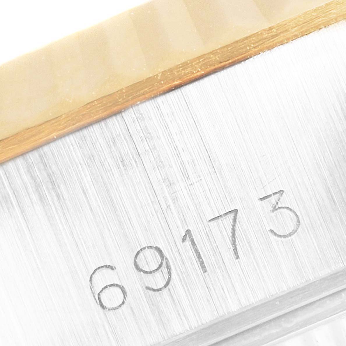 This close-up image shows the serial number "69173" on the side of the bezel of a Rolex Datejust 69173 Women's Steel and Gold (two tone) Champagne Dial 69173 Women's Steel and Gold (two tone) Champagne Dial watch.