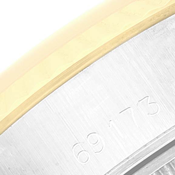 This close-up image of a Rolex Datejust 69173 Women's Steel and Gold (two tone) White Dial 69173 Women's Steel and Gold (two tone) White Dial watch shows a portion of the case with the model number engraved.