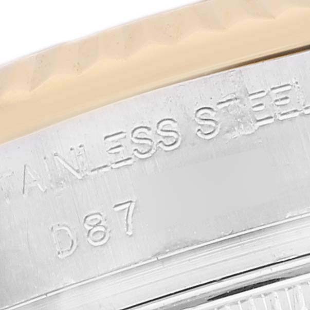 This is a close-up image of the Rolex Datejust 179173 Women's Steel and Gold (two tone) White Dial 179173 Women's Steel and Gold (two tone) White Dial watch, focusing on the stainless steel text and part of the fluted bezel.