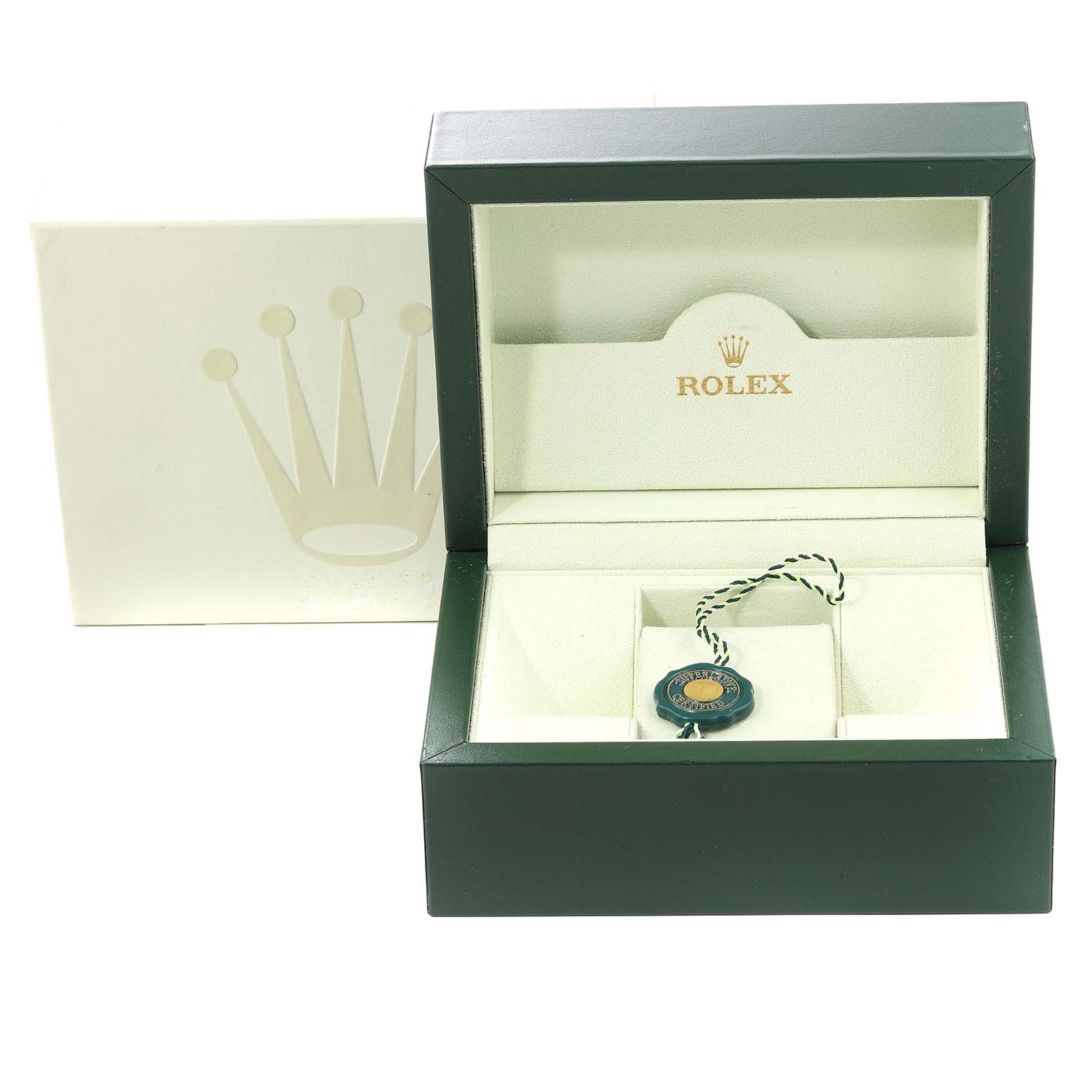 This image shows an open Rolex Datejust 179173 Women's Steel and Gold (two tone) White Dial 179173 Women's Steel and Gold (two tone) White Dial watch box along with its white outer box and a green and gold hang tag.