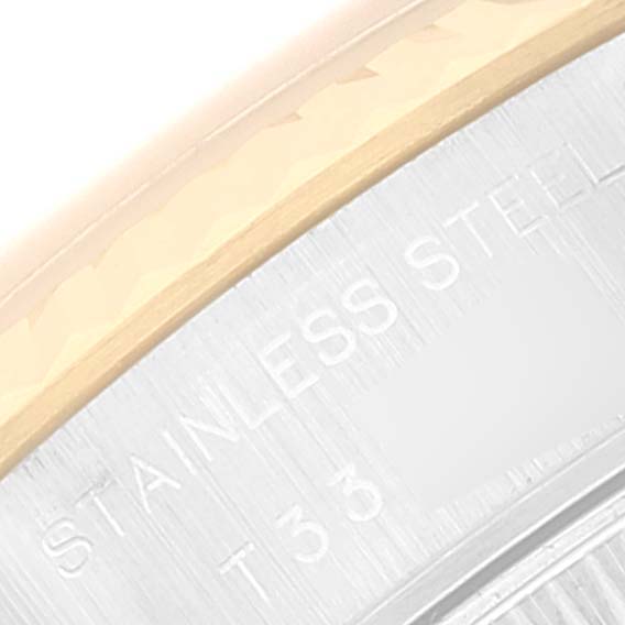 This image shows a macro view of the bezel and the engraved "STAINLESS STEEL" marking on a Rolex Datejust 69173 Women's Steel and Gold (two tone) White Dial 69173 Women's Steel and Gold (two tone) White Dial watch.