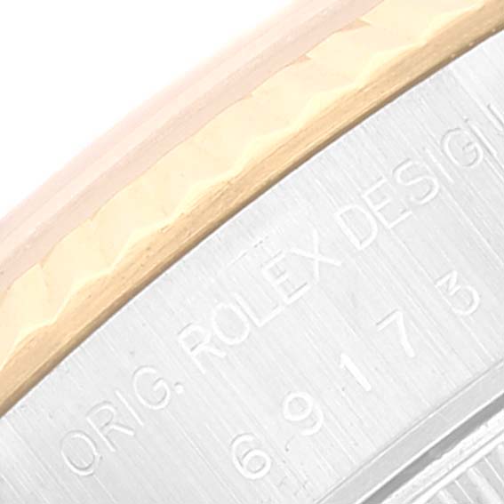 This close-up image shows the side engraving and the edge of the bezel of a Rolex Datejust 69173 Women's Steel and Gold (two tone) White Dial 69173 Women's Steel and Gold (two tone) White Dial watch.