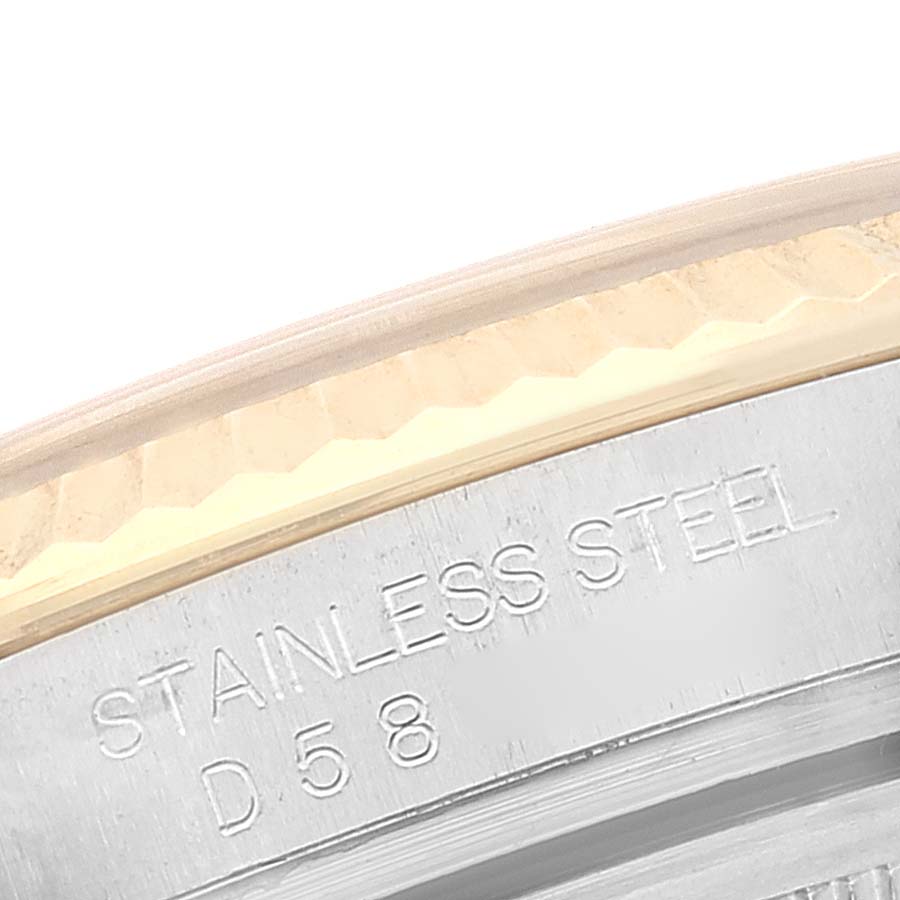 This image shows a close-up of the stainless steel case and the edge of the bezel of a Rolex Datejust 116233 Men's Steel and Gold (two tone) White Dial 116233 Men's Steel and Gold (two tone) White Dial watch.