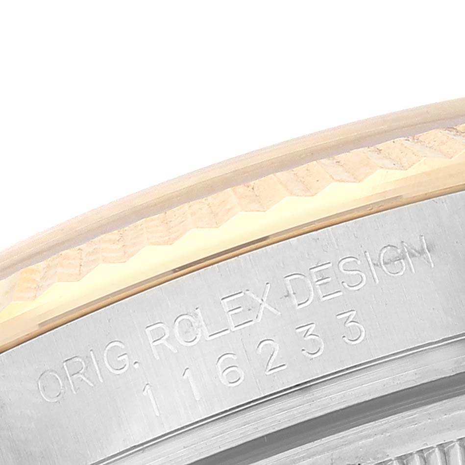 The image shows a close-up of the engraved case back of a Rolex Datejust 116233 Men's Steel and Gold (two tone) White Dial 116233 Men's Steel and Gold (two tone) White Dial model, highlighting its design and reference number.