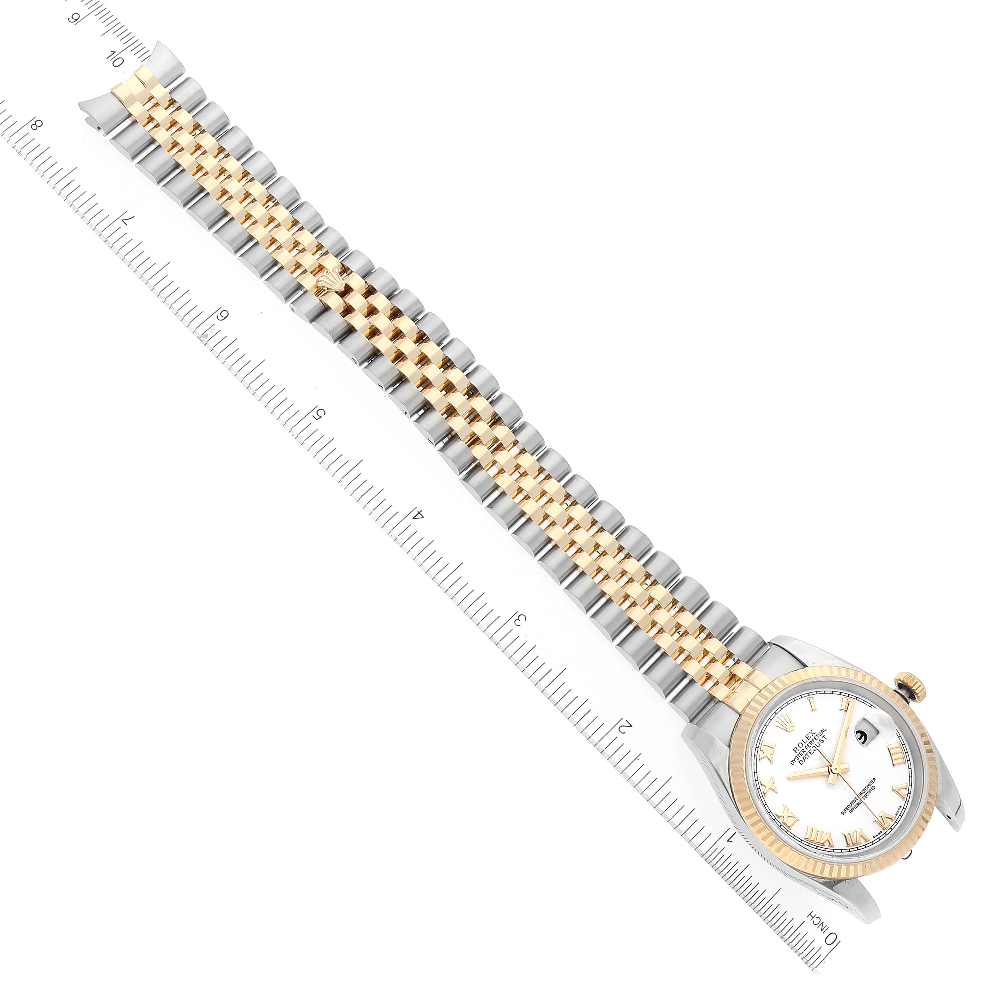 The Rolex Datejust 116233 Men's Steel and Gold (two tone) White Dial 116233 Men's Steel and Gold (two tone) White Dial model watch is shown from a top-down angle, displaying the face, bezel, and bracelet with a ruler for scale.