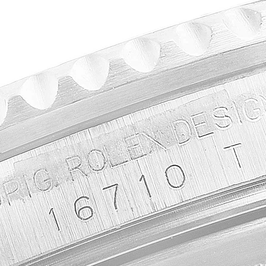 The image shows a close-up of the side of the case and bezel with the engraved model number of a Rolex GMT-Master 16710 Men
s Stainless Steel Black Dial 16710 Men
s Stainless Steel Black Dial.