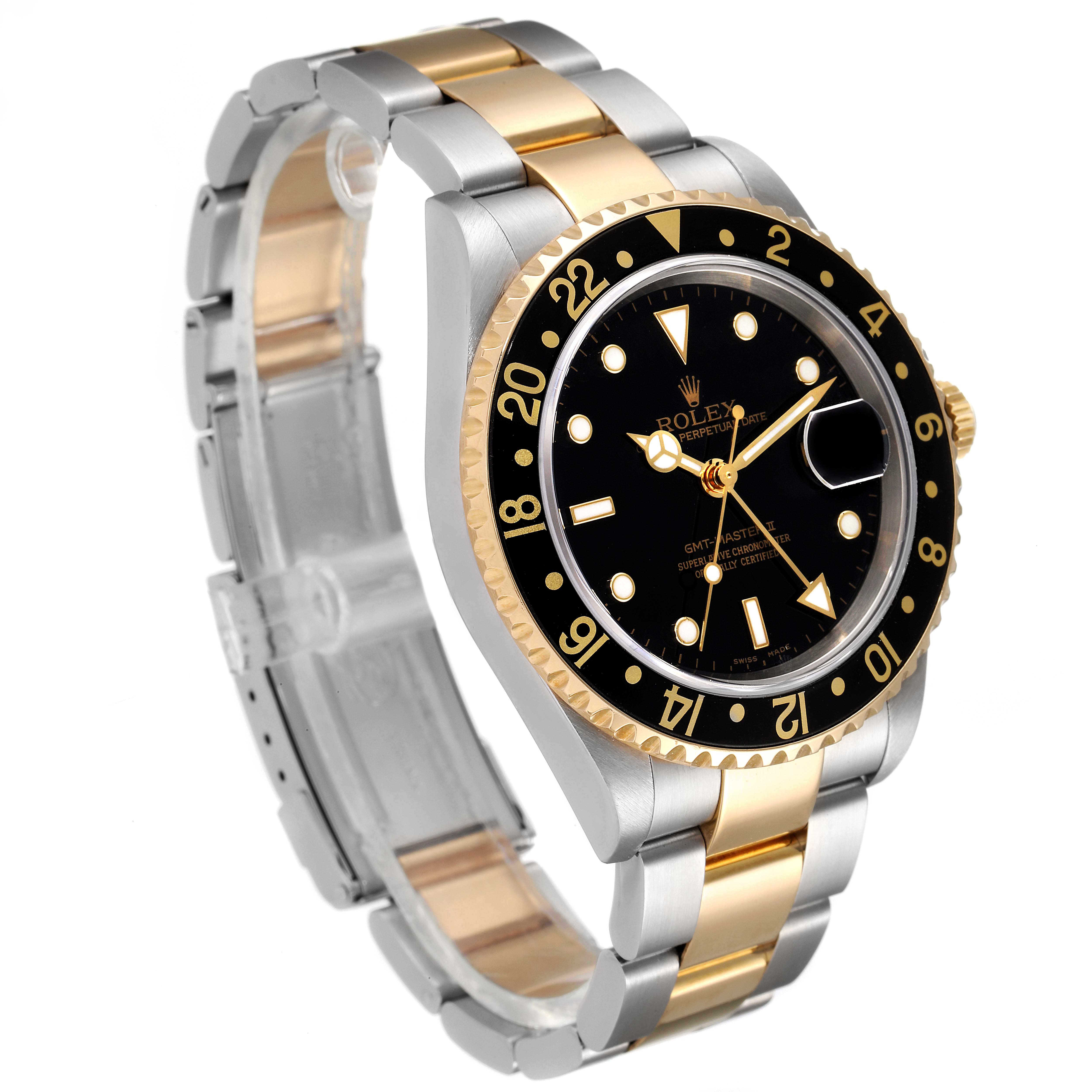 The image shows a Rolex GMT-Master 16713 Men's Steel and Gold (two tone) Black Dial 16713 Men's Steel and Gold (two tone) Black Dial watch angled to display the dual-tone bracelet, black dial, and bezel with gold accents.