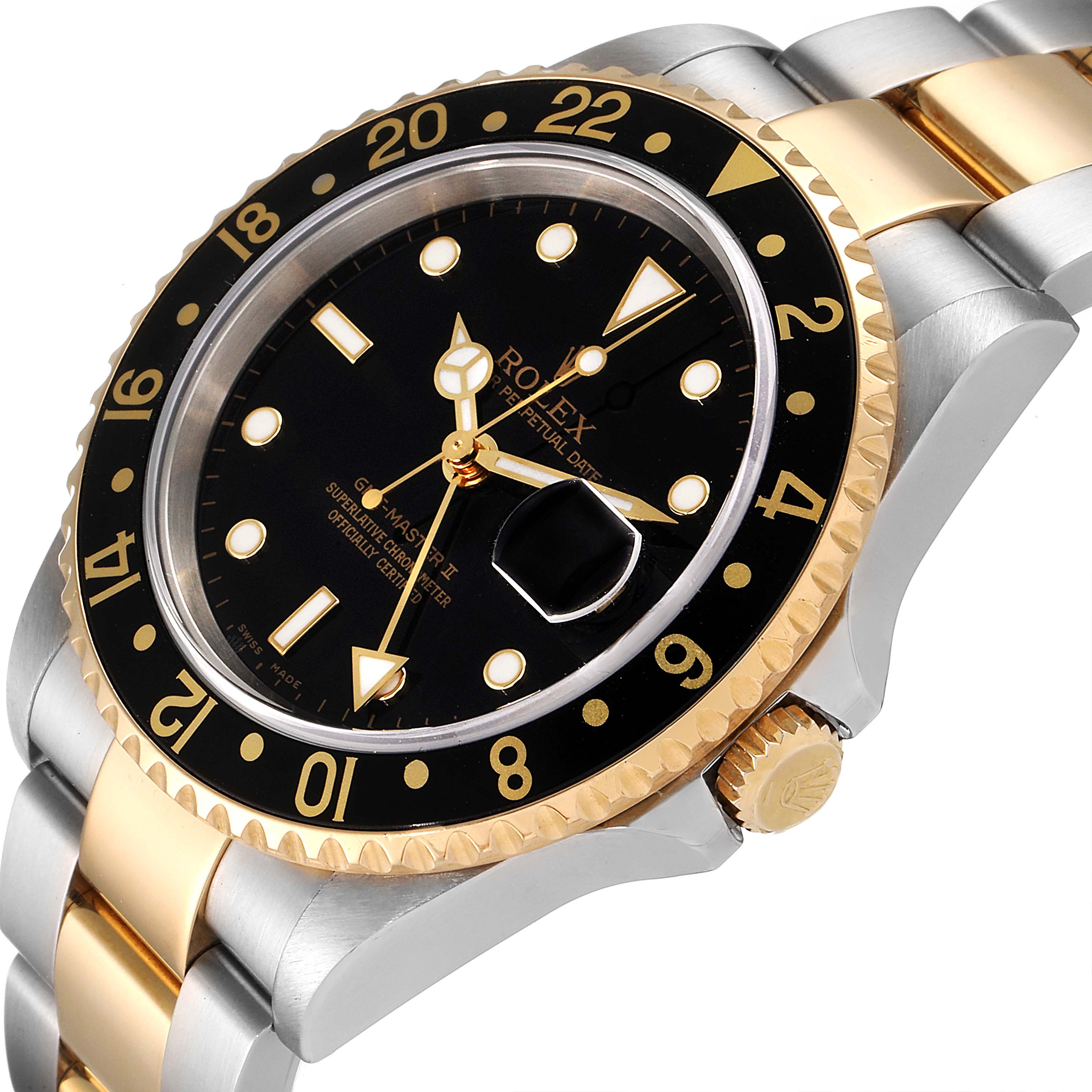 The image shows a Rolex GMT-Master 16713 Men's Steel and Gold (two tone) Black Dial 16713 Men's Steel and Gold (two tone) Black Dial watch at an angled side view, highlighting the black dial, bezel, crown, and two-tone bracelet.