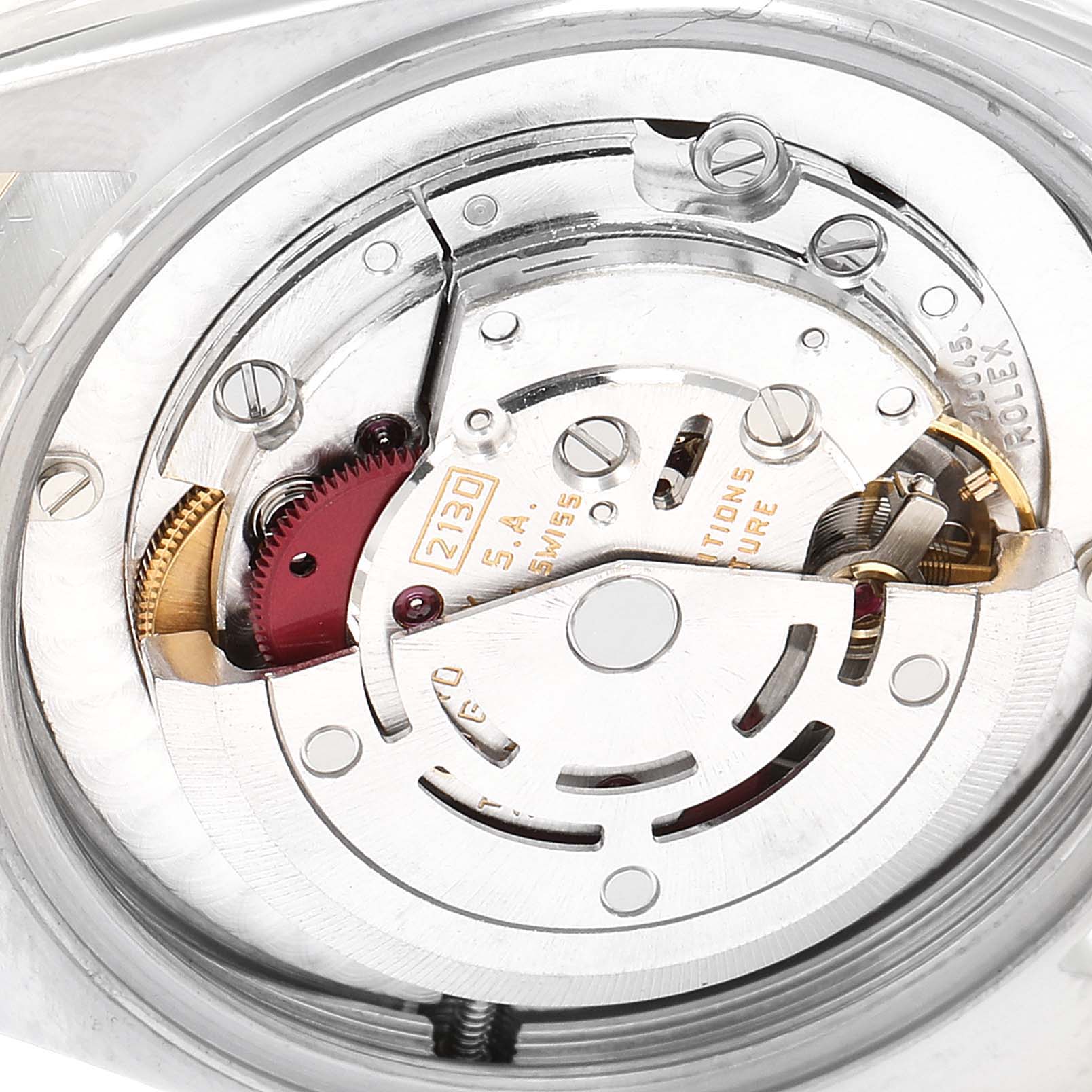 This image shows a close-up of the movement mechanism inside a Mid-Size Rolex watch, model 2130, including gears and screws.