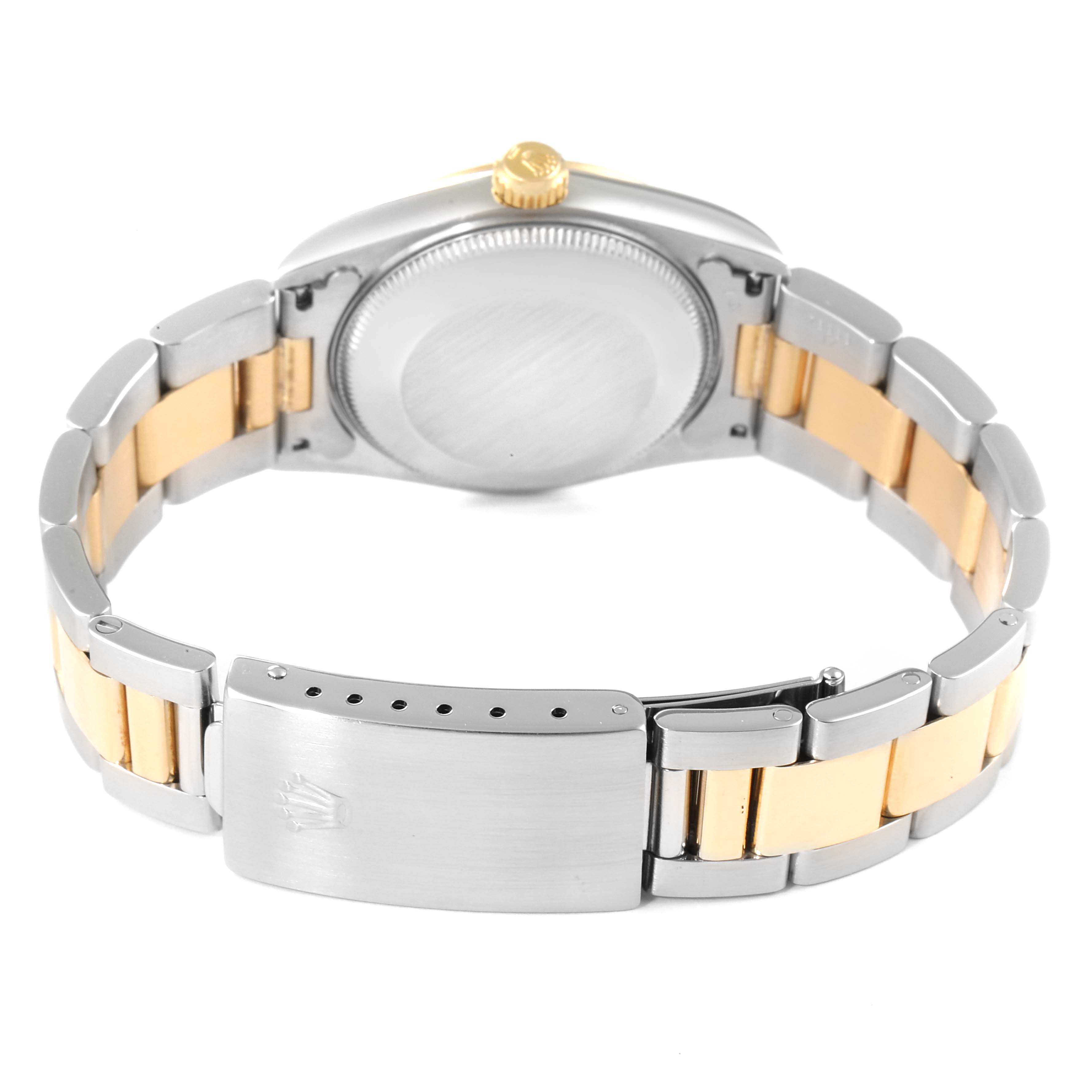 The image shows the back view and band of a Rolex Mid-Size 67483 Women
s Steel and Gold (two tone) White Dial 67483 Women
s Steel and Gold (two tone) White Dial model watch.