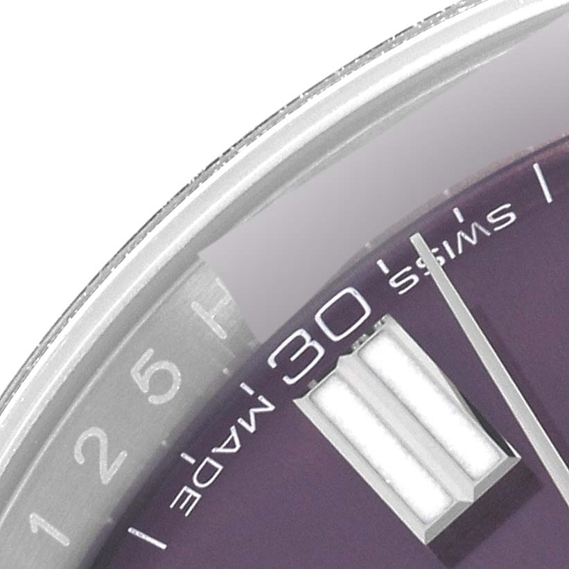 The image shows a close-up of the minute markers and part of the dial of a Rolex Oyster Perpetual 116000 Men's Stainless Steel Purple Dial 116000 Men's Stainless Steel Purple Dial watch.