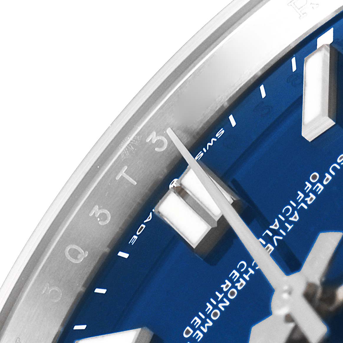 This close-up image of a Rolex Oyster Perpetual 124300 Men
s Stainless Steel Blue Dial 124300 Men
s Stainless Steel Blue Dial watch showcases part of the dial, hour markers, and minute hand.