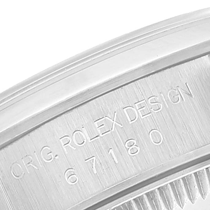 This image shows a close-up of the engraved case back of a Rolex Oyster Perpetual 67180 Women's Stainless Steel White Dial 67180 Women's Stainless Steel White Dial watch.
