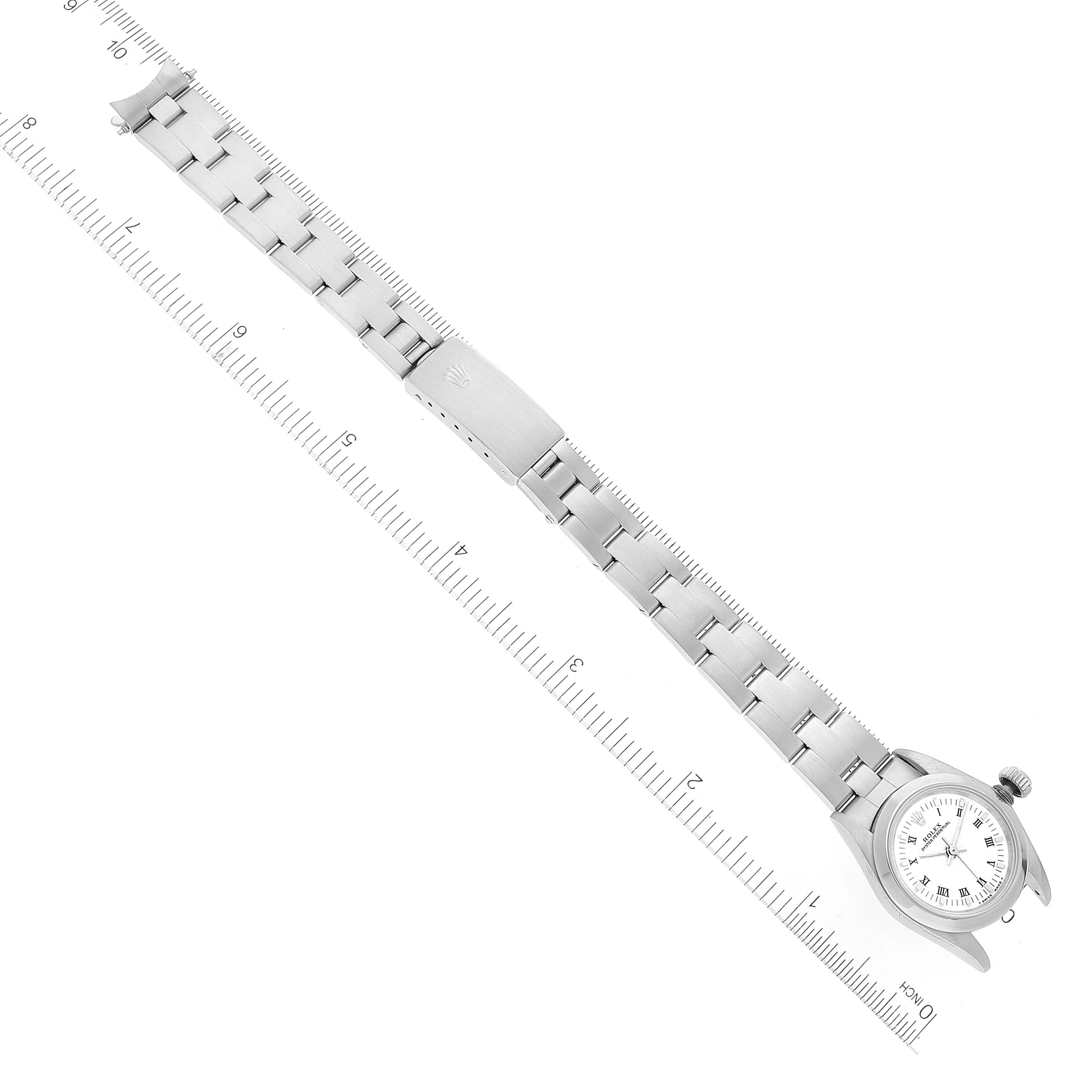 The image shows a Rolex Oyster Perpetual 67180 Women's Stainless Steel White Dial 67180 Women's Stainless Steel White Dial watch laying flat with a visible bracelet and clasp, and rulers for scale.
