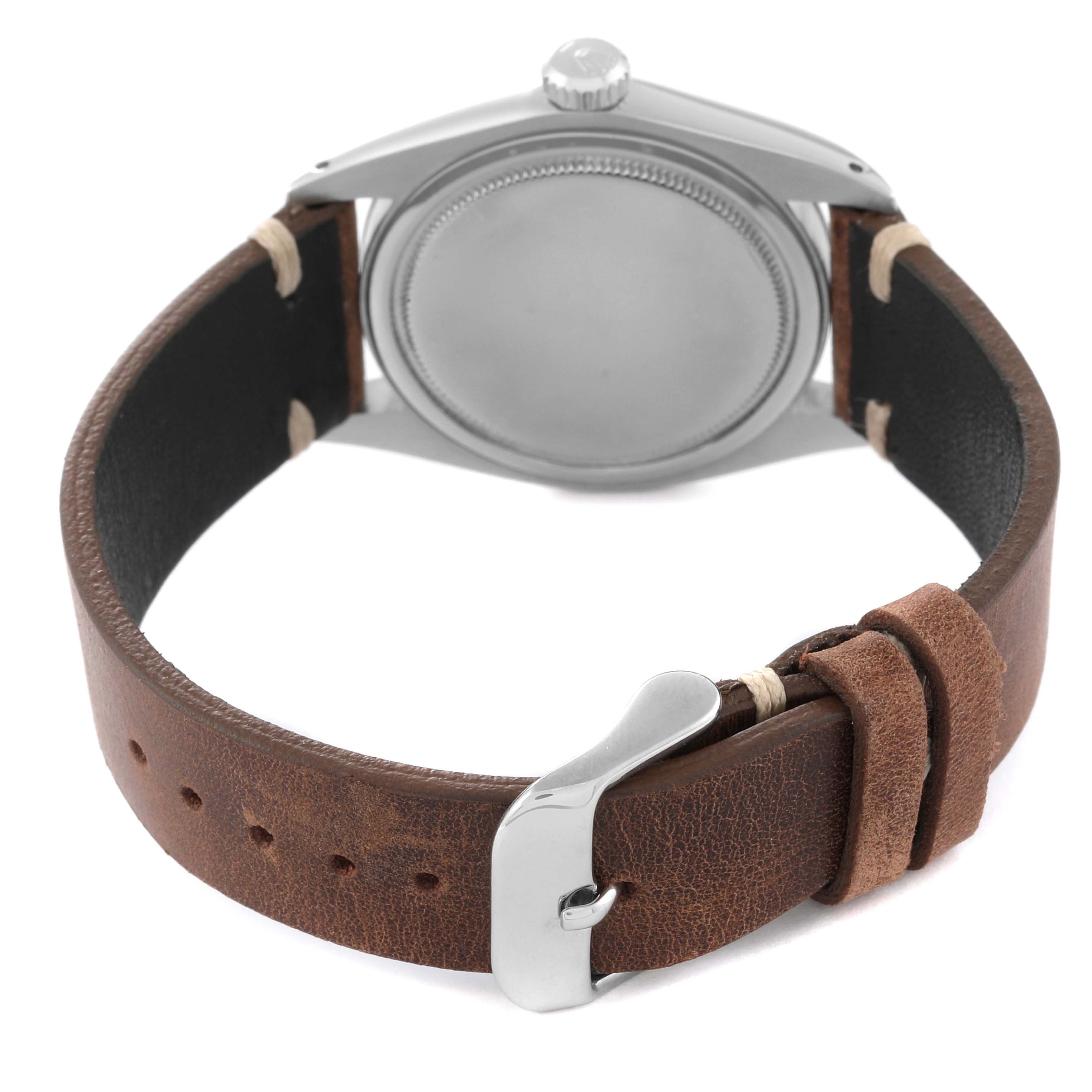 The image shows the back view of a Rolex Vintage Collection 6427 Men's Stainless Steel Silver Dial 6427 Men's Stainless Steel Silver Dial watch with a brown leather strap and stainless steel buckle.