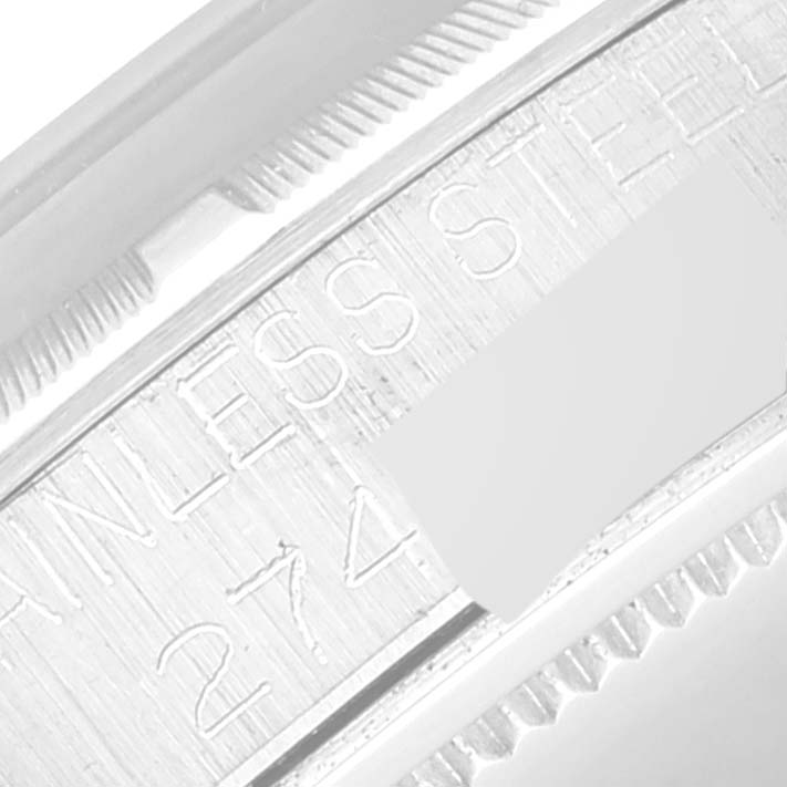 The image shows a close-up of the Rolex Vintage Collection 6427 Men's Stainless Steel Silver Dial 6427 Men's Stainless Steel Silver Dial watch's stainless steel casing and part of its serial number.