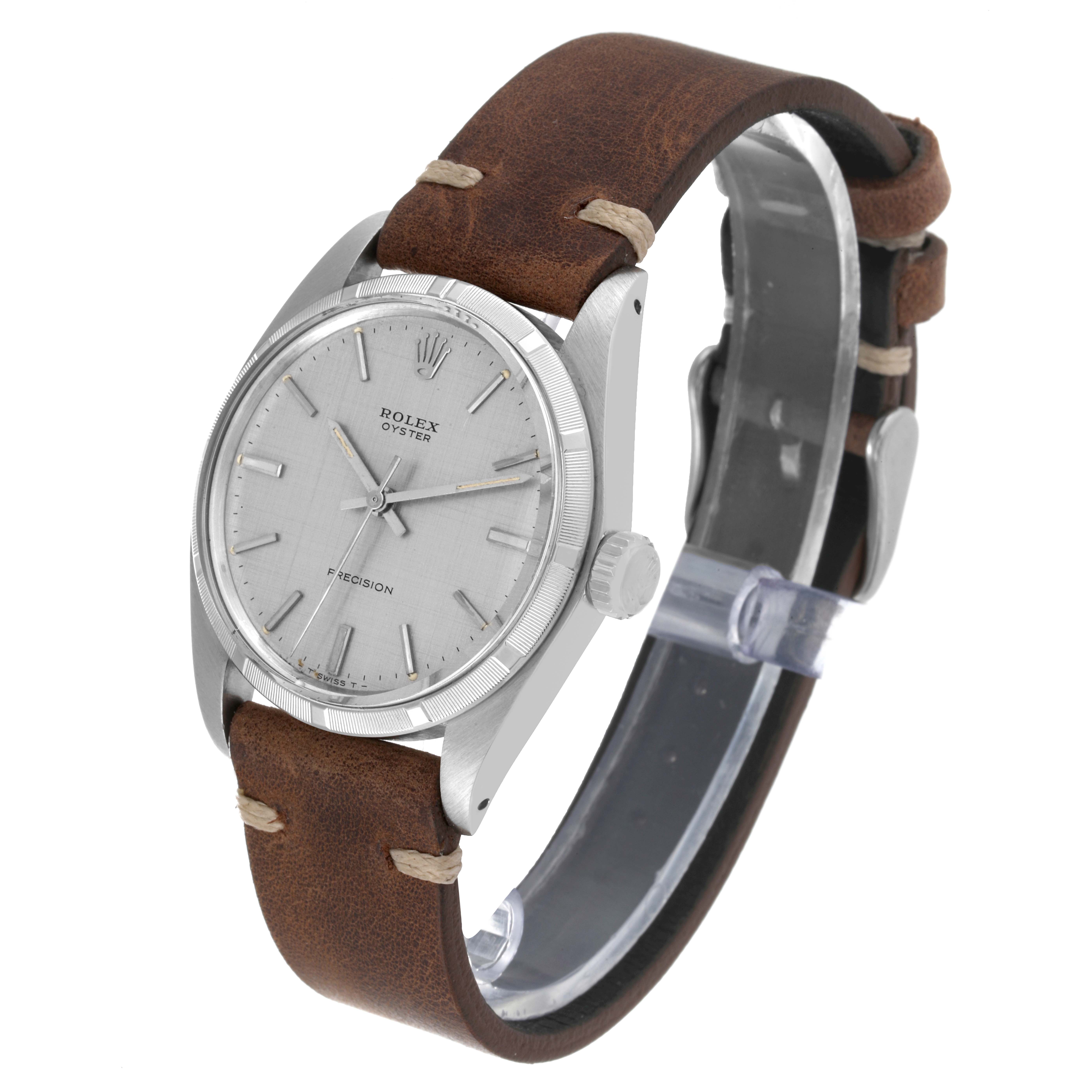 The Vintage Collection Rolex watch is shown at a slight angle, featuring its face, case, crown, and brown leather strap.