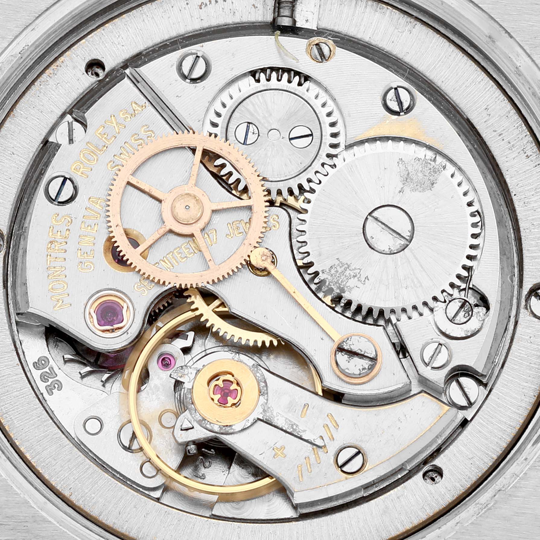 This image shows a close-up of the movement inside a "Vintage Collection" Rolex watch, highlighting gears and mechanical parts.